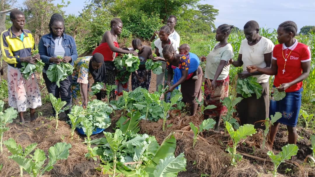 Community members tending vegetables together in a garden